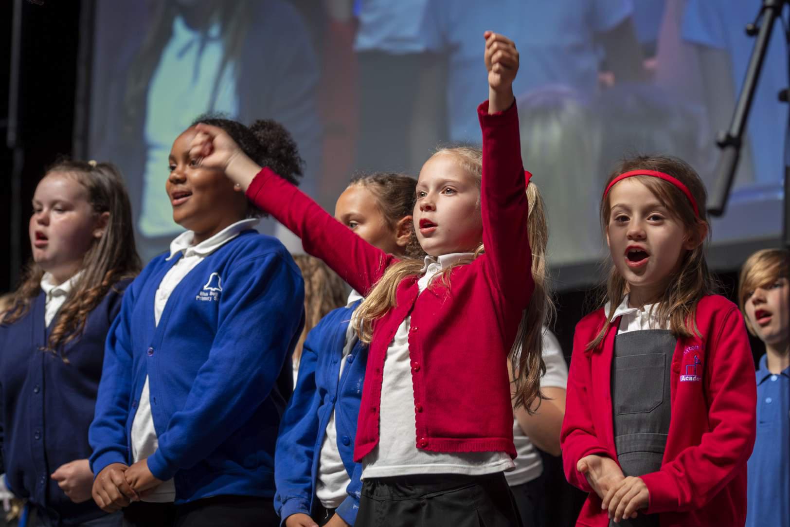 Children performing on stage.