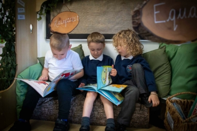 Boys reading books together in school